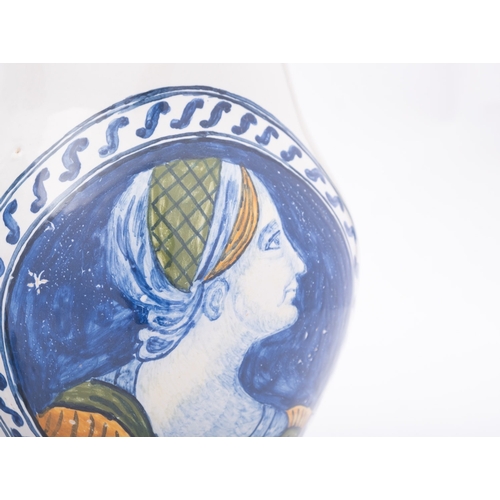 128 - An Italian maiolica baluster 'portrait'  jug  and a Moroccan pottery jug the first 20th century in 1... 