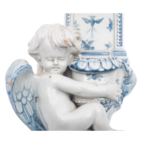 132 - A Cantagalli pottery holy water stoop of traditional form and supported by a putto, painted in blue,... 