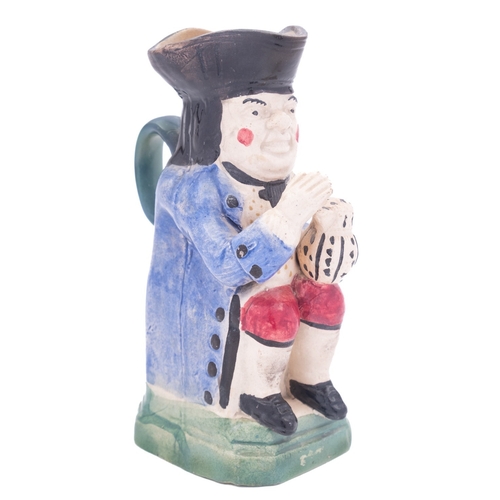 143 - A small pearlware toby jug in Pratt colours and another of Portobello type the first wearing an ochr... 