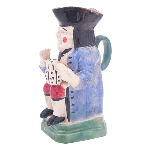 143 - A small pearlware toby jug in Pratt colours and another of Portobello type the first wearing an ochr... 