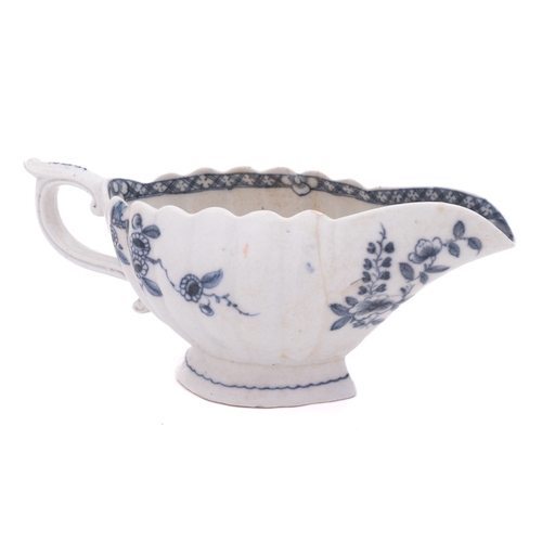 189 - A Plymouth blue and white sauceboat of lobed form with raised foot, painted with flower sprays with ... 