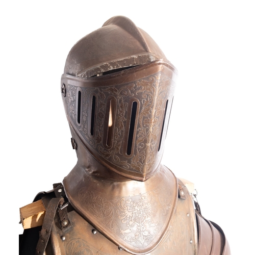 304 - A Victorian engraved iron suit of armour, in Mediaeval style, late 19th century; the helmet with slo... 