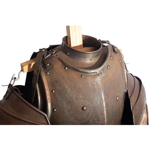 304 - A Victorian engraved iron suit of armour, in Mediaeval style, late 19th century; the helmet with slo... 