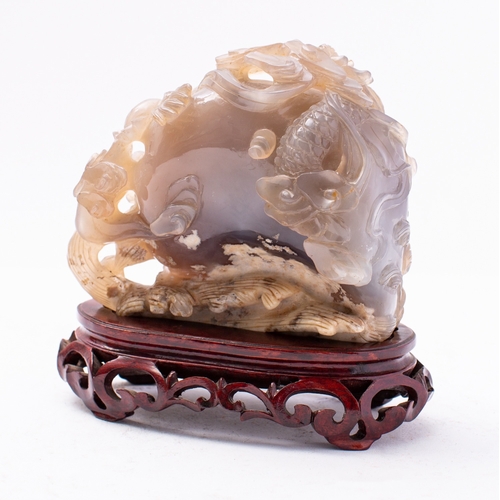 478 - A Chinese agate 'dragon and peach' carving the two dragons climbing over the peach in pursuit of a f... 