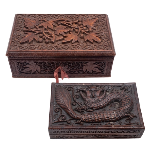 498 - Two South East Asian carved boxes, of rectangular form with hinged lids one carved with mythical bea... 