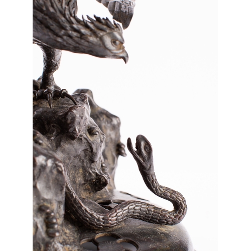 505 - A large Japanese bronze Koro cover, Meiji period in the form of an eagle attacking a snake on a rock... 