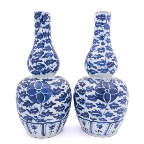 68 - A pair of Chinese blue and white double gourd vases, Xuantong painted with flowers and scrolling fol... 