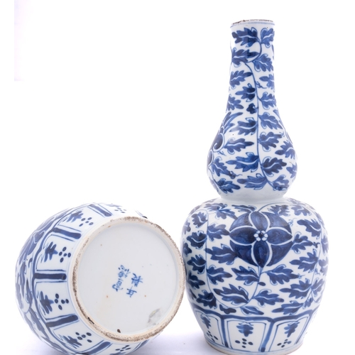 68 - A pair of Chinese blue and white double gourd vases, Xuantong painted with flowers and scrolling fol... 