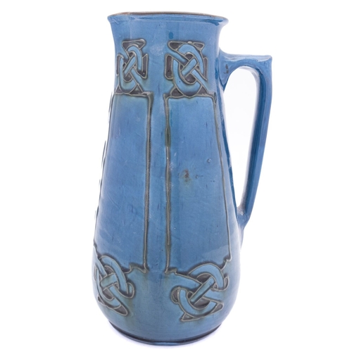 16 - C H Brannam for Liberty & Co. a pottery jug, of tapering cylindrical form tube lined with panels ter... 