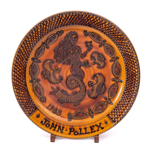 38 - John Pollex [b 1941] a large terracotta charger, slip decorated with a mermaid within a lattice bord... 