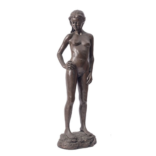 538 - A 'bronzed' resin model of a female nude, 1983; portrayed standing, with head to dexter, the loosely... 