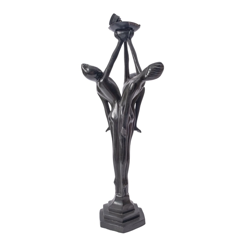 548 - A patinated metal figural table lamp, 20th century; the electrical fitment in a platter held aloft b... 