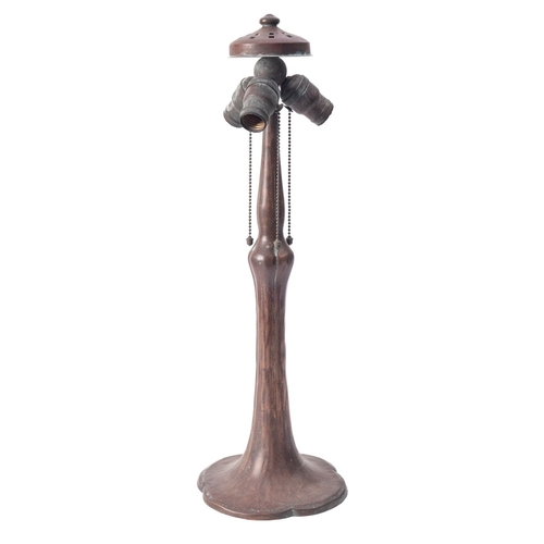 552 - A copper table lamp in Art Nouveau style, circa 1900; with a vented and domed top above three downtu... 