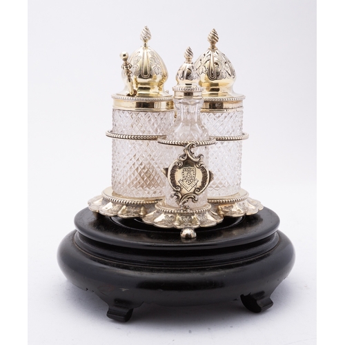 122 - A Victorian silver-gilt and glass three-bottle spice cruet set by John William Figg, London 1872, th... 