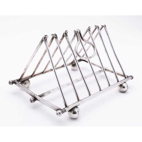 13 - An early 20th century seven bar silver plated folding toast rack, not marked, with tubular bars, con... 