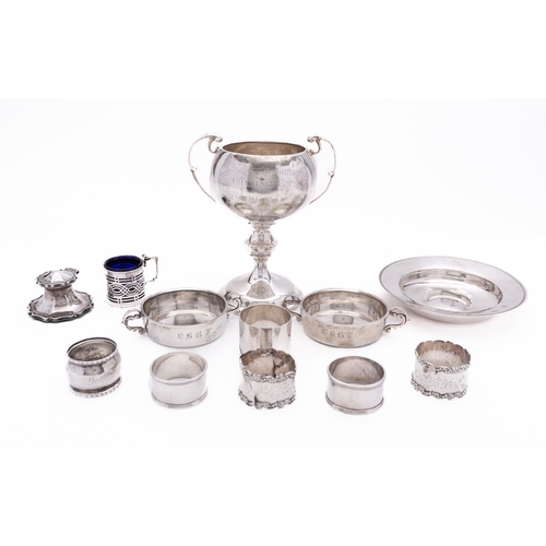 17 - A mixed group of silver including; a North Hants two handled trophy cup, six various napkin rings, a... 