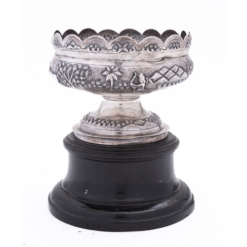 182 - An Indian silver bowl by Mondhuden Bhowanipore Calcutta marked on the base, the wavy rim above an em... 