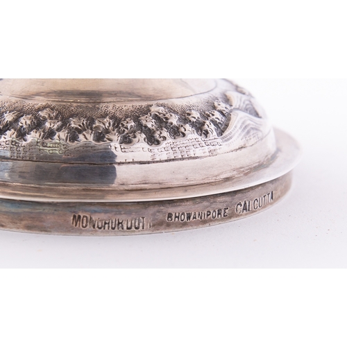 182 - An Indian silver bowl by Mondhuden Bhowanipore Calcutta marked on the base, the wavy rim above an em... 