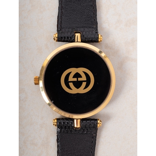 330 - A Gucci 2000M gold-plated wristwatch the round black dial signed Gucci and having the Gucci logo, wi... 