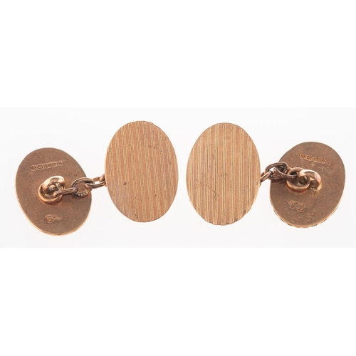 368 - A pair of 9ct rose gold cufflinks, of oval form with engine turned engraving to both panels, chain l... 