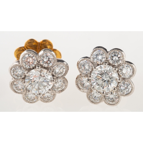 370 - A pair of fine diamond cluster earrings, of flowerhead design, each claw set to the centre with a br... 