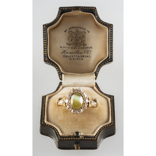 602 - Hamilton & Co. A fine Edwardian cat's eye chrysoberyl and diamond ring, claw set to the centre with ... 