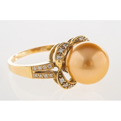 647 - A Golden South Sea pearl and diamond ring, of flowerhead design and set to the centre with a Golden ... 