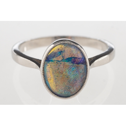 690 - A modern black opal ring, collet set with a black oval opal cabochon, opal measures approx. 10.0mm x... 