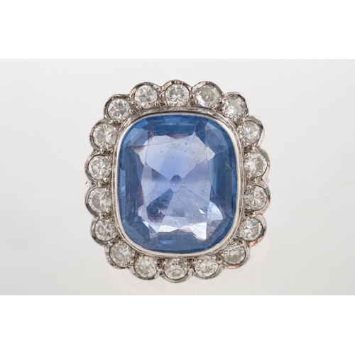 692 - A fine and impressive sapphire and diamond cluster ring, collet set to the centre with a mixed facet... 