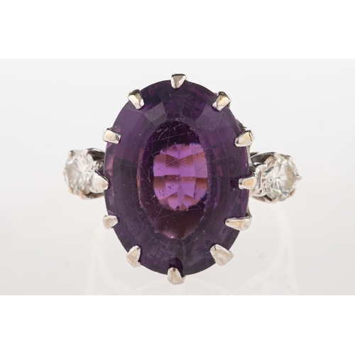 693 - An 18ct gold amethyst and diamond ring, claw set with an oval-cut amethyst, amethyst approx. 14.24 c... 