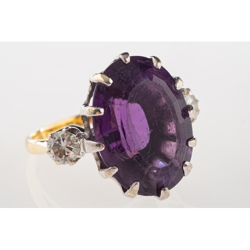 693 - An 18ct gold amethyst and diamond ring, claw set with an oval-cut amethyst, amethyst approx. 14.24 c... 