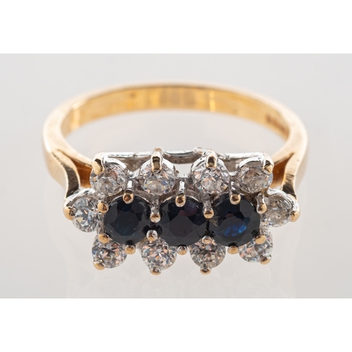 701 - A 9ct gold sapphire cluster ring, claw set with a row of three circular-cut dark blue sapphires with... 