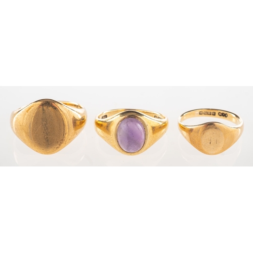 702 - A group of three rings, including a 9ct gold signet ring, UK hallmarks, size F1/2, 2.6grams; a signe... 