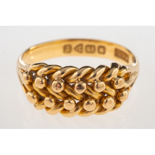 708 - An early 20th century 18ct gold 'keeper' ring, with plait section to front and 'V' split shoulders, ... 