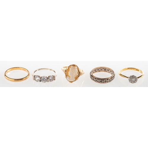 714 - A group of five rings, including a 9ct gold cameo ring, UK hallmark, size L, 1.9grams; a 9ct gold we... 