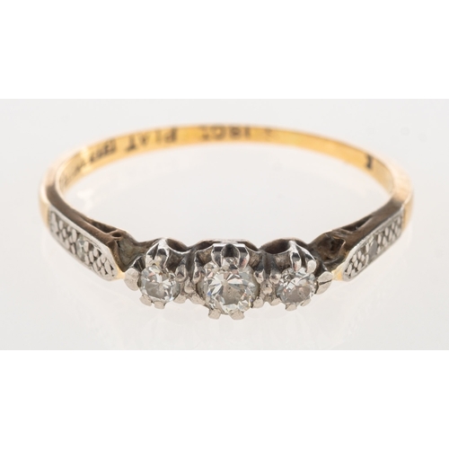 722 - A three stone diamond ring, claw set with three old-cut diamonds, with a single-cut diamond set to e... 