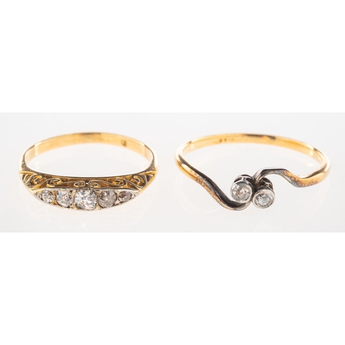 726 - Two diamond set rings, including a ring set with five graduated old-cut diamonds, scroll carved sett... 