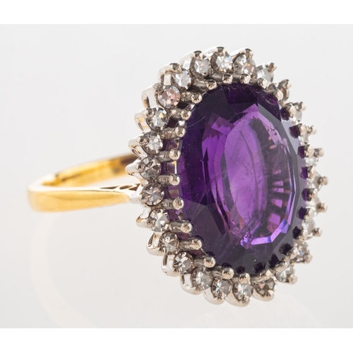 730 - An 18ct gold amethyst and diamond cluster ring, claw set with an oval mixed-cut amethyst, amethyst a... 