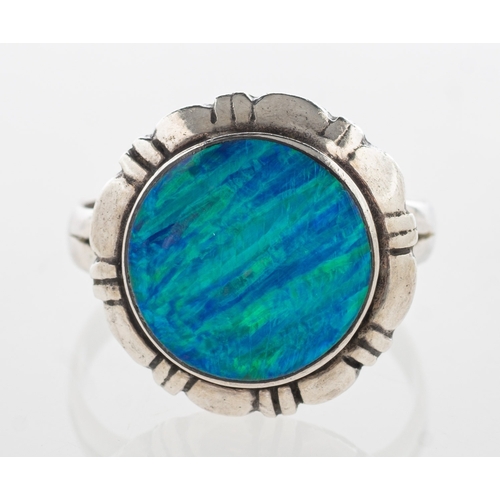 739 - A black opal ring, collet set with a circular plaque of black opal in a carved mount, marked 925, si... 