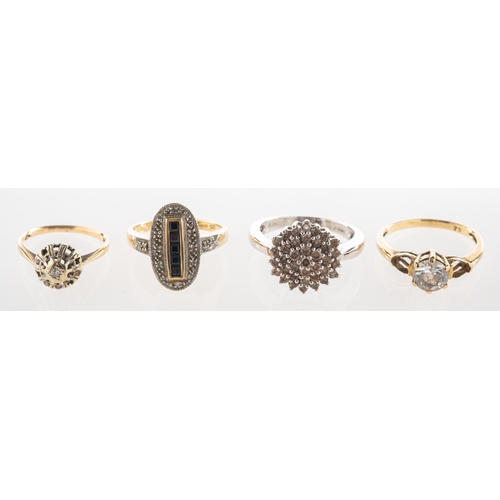 742 - A group of four rings, including a 9ct gold oval shaped ring, channel set with a line of five square... 