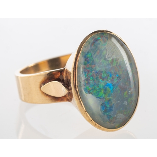 787 - An opal triplet ring, set with an oval opal triplet, marked 9ct, size M1/2, 6.7grams.