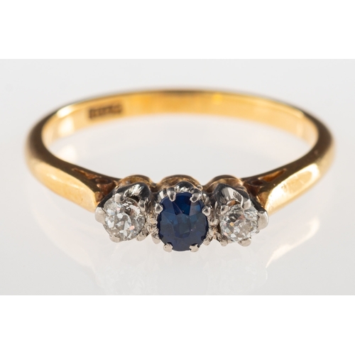 795 - A sapphire and diamond three stone ring, claw set to the centre with an oval-cut sapphire and a bril... 