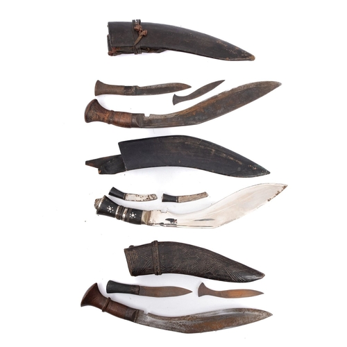 140 - A group of three various kukris  in black leather scabbards (3).