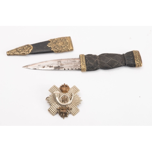 144 - An early 20th century Sgian Dubh, the short blade with rope knot bog oak grip and plated mounts with... 