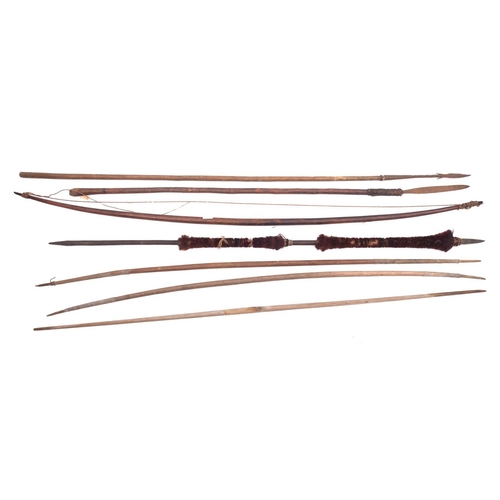 145 - A group of  four various tribal bows , together with two spears and a hair mounted spear (7)