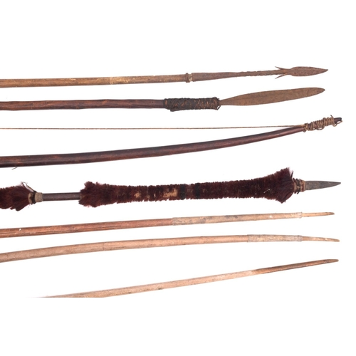 145 - A group of  four various tribal bows , together with two spears and a hair mounted spear (7)