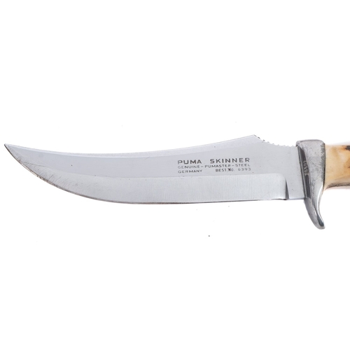 158 - A Puma Skinner stainless steel hunting knife. Serial number 76582 having a curved blade and antler h... 