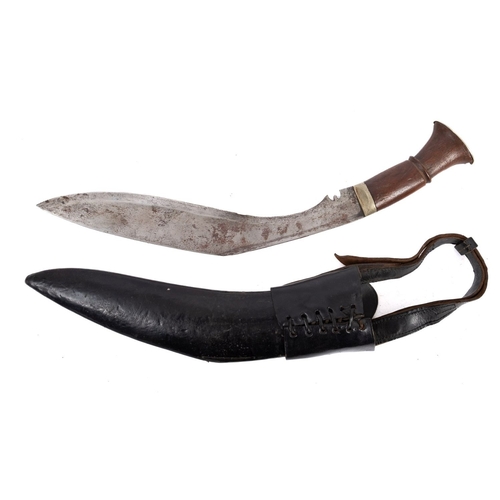 161 - A mid 20th century kukri, of traditional form with wooden grip in a black leather scabbard, blade le... 