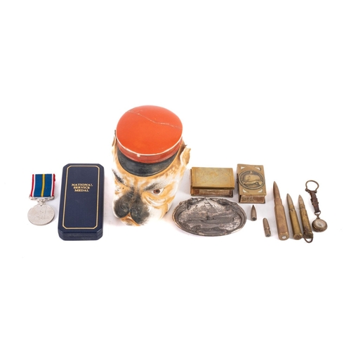 205 - A mixed group of collectables, comprising;- two early 20th century brass matchbox holders, a WWI Ger... 