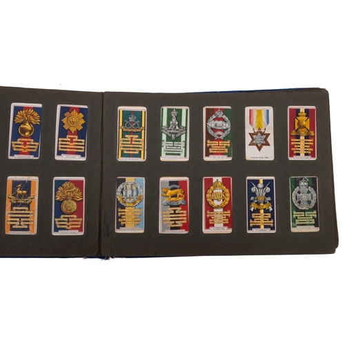 567 - A collection of sets and part sets of cigarette cards in a blue album. Including Gallaher Ltd Aeropl... 